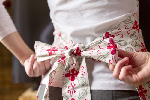 tying-on-apron