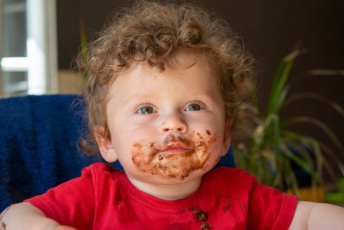 Young Toddler with His Face Covered in Chocolate