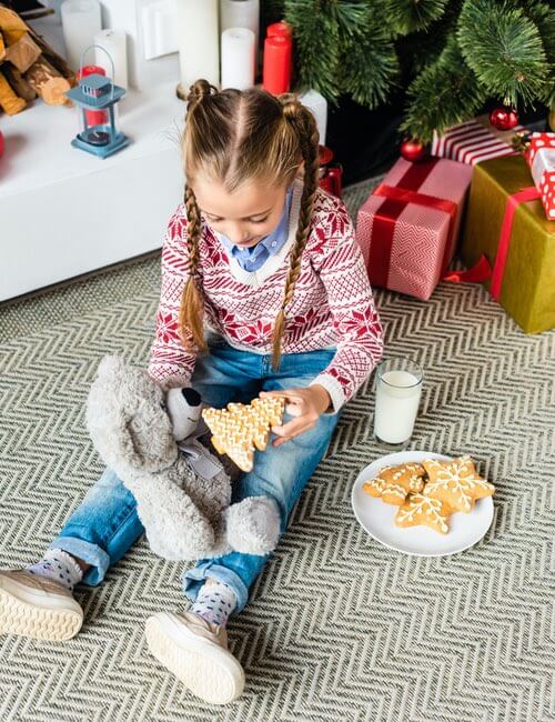 Little Girl Feeding Gingerbread Cookies to Her Teddy Bear