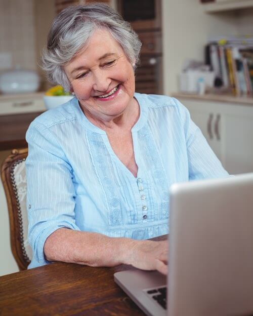 Lady Reading Cooking Hints and Tips on Her Laptop Computer