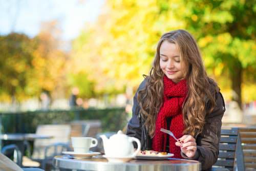 Young Girl Enjoys Eating French Crepes