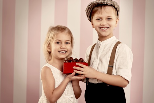 Young Boy Giving Valentine Chocolates to a Young Girl