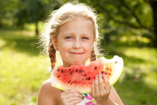 Girl With Pigtails Eating a Watermelon