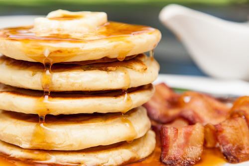 Stack of Homemade Pancakes With Butter, Syrup and Bacon