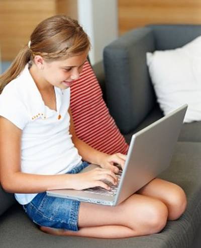 Young Girl Reading on a Laptop Computer