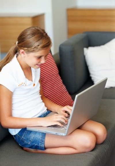 Young Student Researching Vintage Recipes with a Laptop Computer