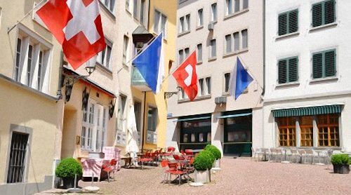 Enjoying Swiss Desserts at an Outdoor Cafe in Zurich