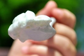 Child holds a Spoonful of Coffee Can Ice Cream