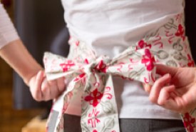 Young Woman Tying Her Apron