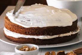 Spreading White Icing on a Homemade Cake