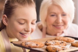 Young Girl Baking Cookies with Her Grandma