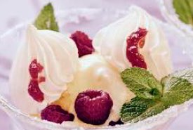 Bowl of Pineapple Ice Cream Topped with Raspberries and Meringue