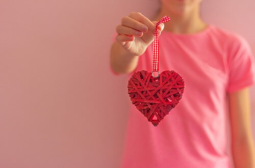 Young Girl Holding a Valentine Heart Decoration