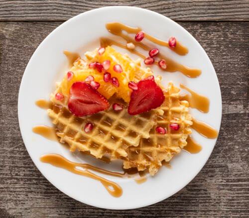 Homemade Waffles with Strawberries, Orange Sections, and a Favorite Topping