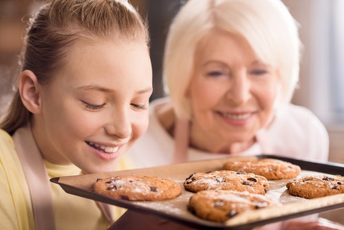 Grandmother and Granddaughter Baking Cookies