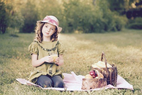 Young Girl Enjoys Her Picnic Food