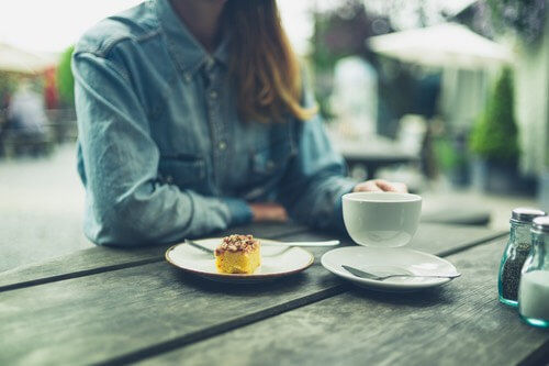 Young Lady Eating an Orange Cake Dessert Outdoors